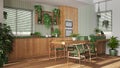 Biophilia interior design, wooden kitchen in white and green tones with many houseplants. Island with chairs and appliances. Urban Royalty Free Stock Photo