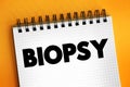 Biopsy - extraction of sample cells for examination to determine the presence or extent of a disease, text concept on notepad