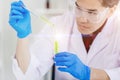 Bioscience Scientist working in medical lab to research and develop new drug by natural essence chemical extraction from leaves