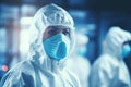 Biotech worker in cleanroom with protective gear in pharmaceutical industry facility Royalty Free Stock Photo