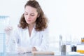 Biotechnologist dissolving sample in solution Royalty Free Stock Photo