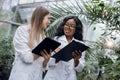 Biotechnology, agronomy, science and engineering concept. Two cheerful female scientists making research, working in