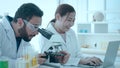 Biotechnology researcher scientist working look microscope in the medical development laboratory for vaccine development. Royalty Free Stock Photo