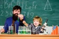 Biotechnoloy research concept. bearded man teacher with little boy. Back to school. Explaining biology to child. father