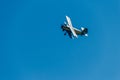 Biplane flying in blue sky Royalty Free Stock Photo