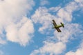 Biplane flying in blue sky at Air Show