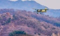 Biplane flying over mountainous region