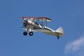 Biplane in Red, White and Blue Flying Royalty Free Stock Photo