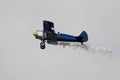 biplane smoke plume air show old aircraft Royalty Free Stock Photo