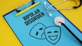 Bipolar disorder is shown using the text and picture of happy and sad masks Royalty Free Stock Photo
