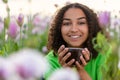 Biracial African American Teenager Woman Drinking Coffee in Flowers Royalty Free Stock Photo