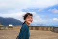 Teen girl standing at Pali Lookout on hot sunny day