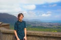 Teen girl standing at Pali Lookout on hot sunny day
