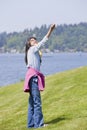 Biracial asian girl flying kite by lake Royalty Free Stock Photo