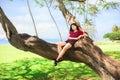 Teen girl in tree at Kawaikui Beach park, Oahu, Hawaii Royalty Free Stock Photo