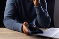 Biracial businessman using smartphone and laptop on grey background Royalty Free Stock Photo