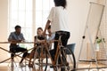 Biracial female employee ride bike in modern office