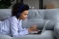 Biracial female student study on laptop at home