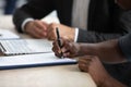 Biracial man sign document close deal at meeting Royalty Free Stock Photo