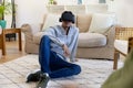 Biracial man using vr headset sittiing on floor at home Royalty Free Stock Photo