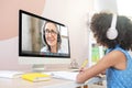 Biracial schoolgirl studying with video online lesson at home Royalty Free Stock Photo