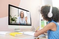 Biracial schoolgirl studying with video online lesson at home Royalty Free Stock Photo