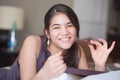 Biracial teen girl reading book in bed at night Royalty Free Stock Photo