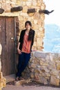 Biracial teen girl relaxing, leaning against rock wall overlooki Royalty Free Stock Photo