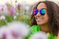 Biracial Young Woman Girl Teenager in Field of Flowers Wearing Sunglasses Royalty Free Stock Photo