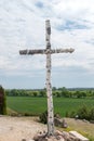 Birch cross next to statue of Christ the King in Swiebodzin