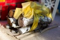 Birch firewood lies next to an artificial fireplace, tied with a golden ribbon
