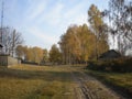 Dirt road in the foreground,path, country house forest behind the Birch, autumn, tree shadows