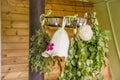 Birch, juniper,oak tree sauna whisks brooms also known as vasta, vihta or venik hanging and drying. Felt woman sauna hat at spo Royalty Free Stock Photo