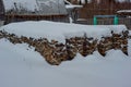 Birch split firewood stacked in a bonfire lying under the snow Royalty Free Stock Photo