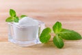 Birch sugar xylitol in a glass bowl with mint on wooden closeup