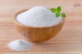 Birch sugar xylitol in a wood bowl with mint on wooden