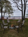 Picnic firewood relax chairs fire pit Sandy beach Lake water horizon Birch tree trunk branches white