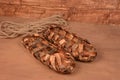 Birchen woven bast shoes hang on a log wall Royalty Free Stock Photo