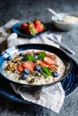 Bircher muesli with strawberries, blueberries, chia seeds, walnuts, sunflower seeds and pumpkin seeds