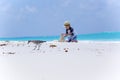 Bird on the beach and boy making sand castles Royalty Free Stock Photo