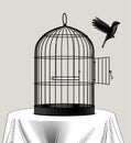 Bird cage and a black bird flying away