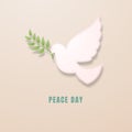 Bird dove with an olive branch in honor of the International Day of Peace. Royalty Free Stock Photo