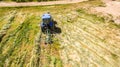 Bird eye of Hay rake tractor turning the hay Royalty Free Stock Photo