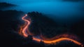 A bird eye scenery view of a winding road cutting turns through clouds of serpentine a dense forest , mountain landscape.Top Down Royalty Free Stock Photo