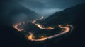 A bird eye scenery view of a winding road cutting turns through clouds of serpentine a dense forest , mountain landscape.Top Down Royalty Free Stock Photo