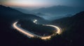 A bird eye scenery view of a winding road cutting turns through clouds of serpentine a dense forest , mountain landscape.Top Down Royalty Free Stock Photo