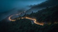 A bird eye scenery view of a winding road cutting turns through clouds of serpentine a dense forest , mountain landscape.Top Down Royalty Free Stock Photo