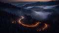 A bird eye scenery view of a winding road cutting turns through clouds of serpentine a dense forest , mountain landscape.Top Down Royalty Free Stock Photo