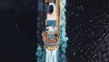 Bird eye top view of large cruiser ship in deep blue water in a sunny day, luxury concept. Stock. Aerial view of luxury