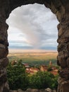 Bird's eye through the window of the old castle in view of the Alazani Valley, the clouds in the sky sunset